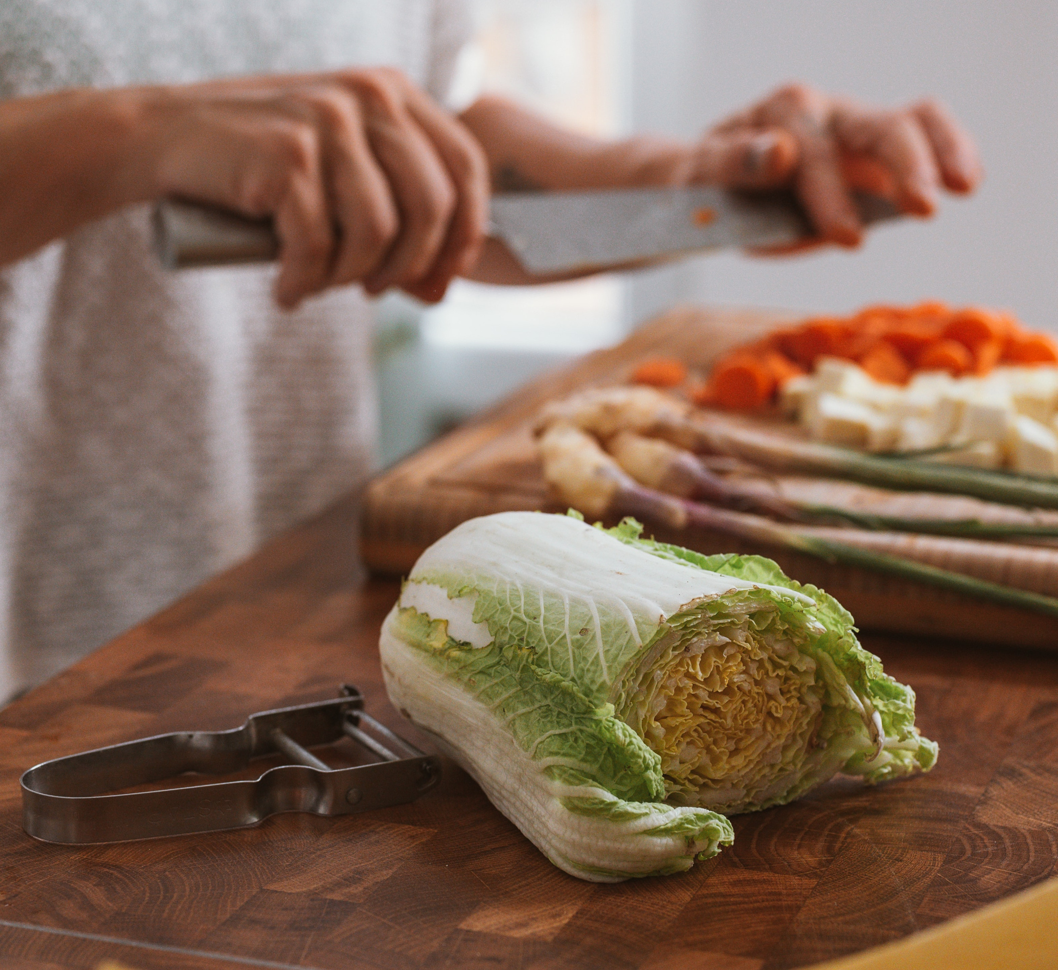 Man cuts salad and prepares to cut cabbage